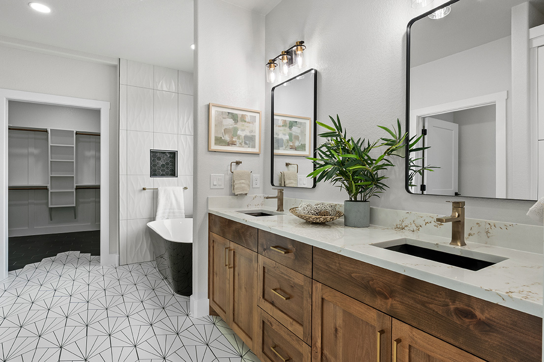 Primary bath with soaking tub, dual vanity and brass hardware