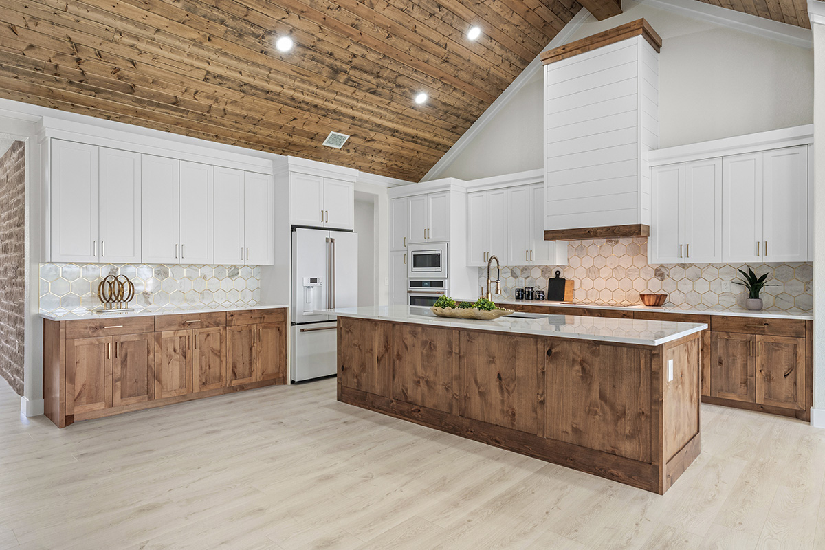 Custom kitchen with knotty alder island and shiplap hood