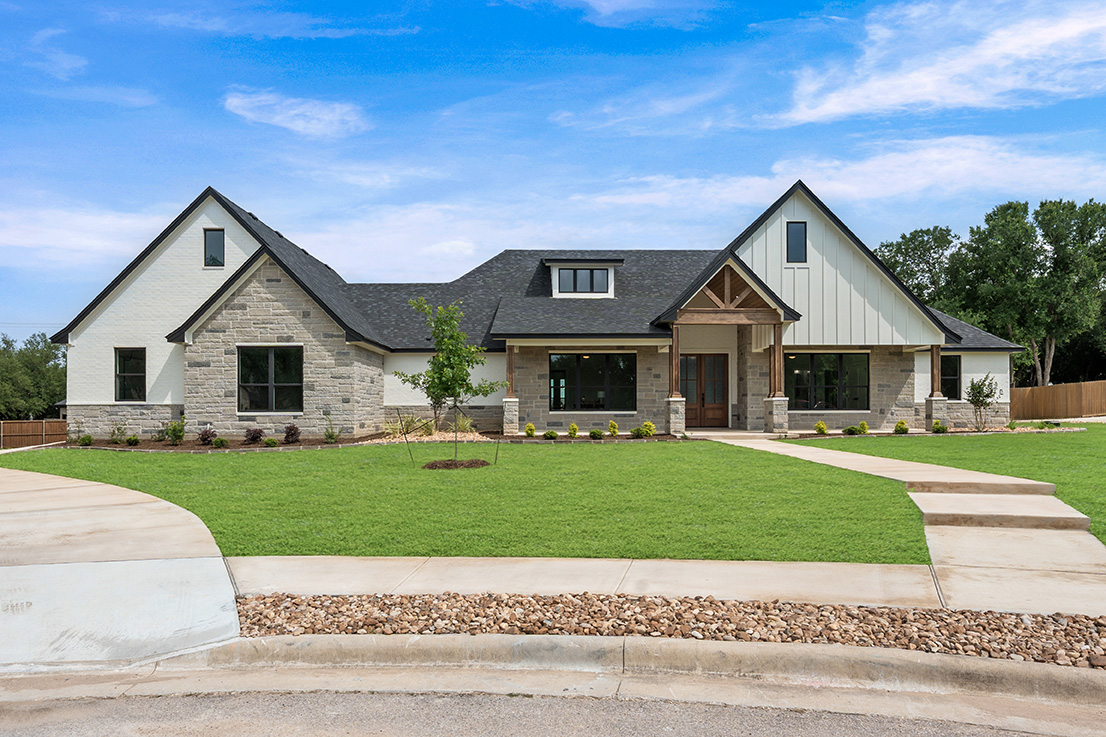 The Ambrose — stone and board-and-batten custom home exterior