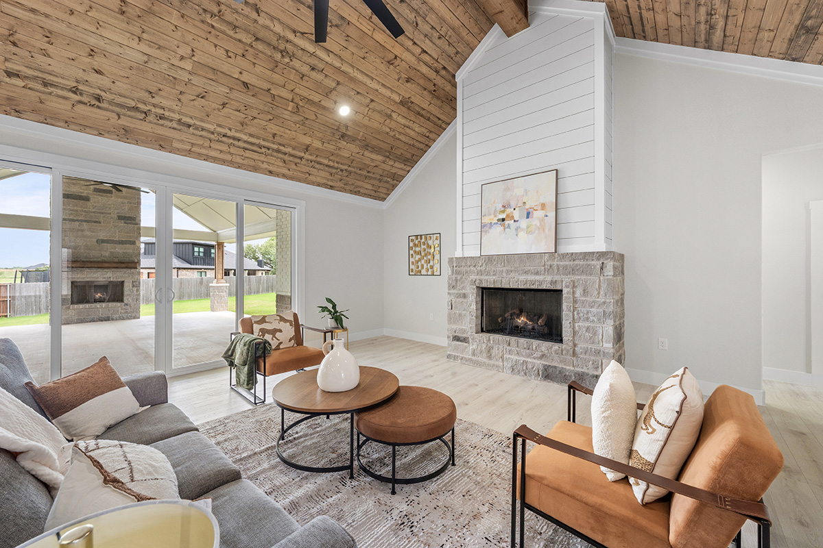 Vaulted living room with wood plank ceiling and stone fireplace