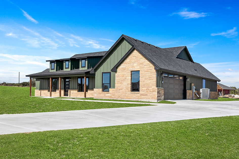 Green and stone custom home with side-entry garage